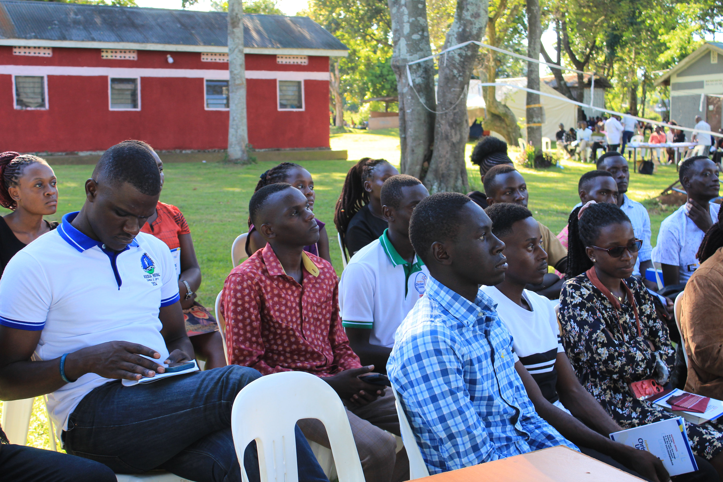 Students seated on the lawn during a conference at the FOCUS campsite